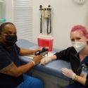 Holly sits with a patient