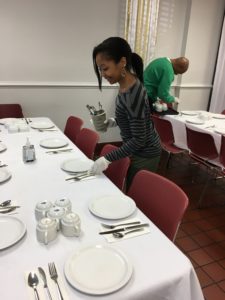 A Volunteer Sets The Table