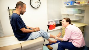 Nurse Practitioner provides foot care for patient